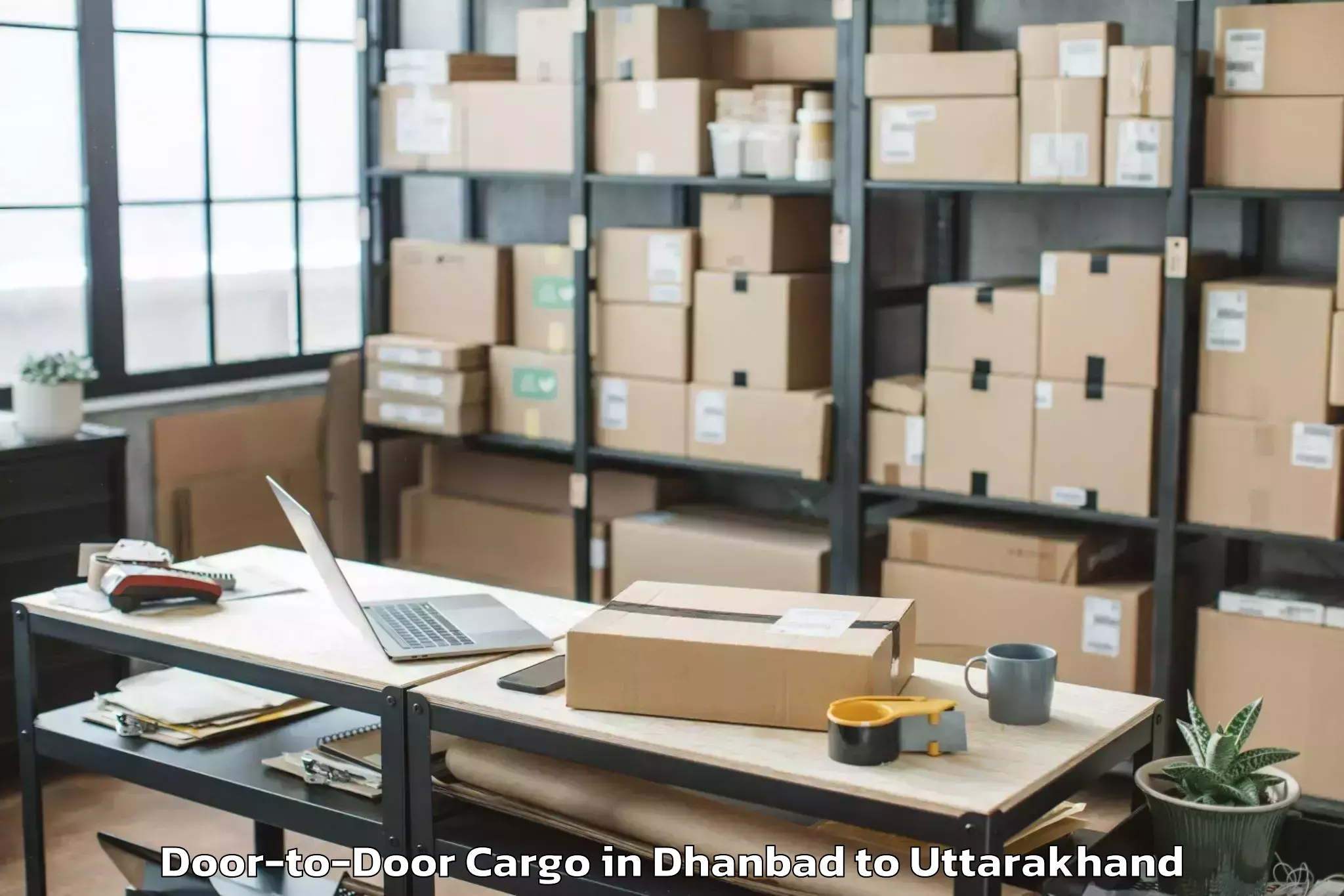 Leading Dhanbad to Clement Town Door To Door Cargo Provider